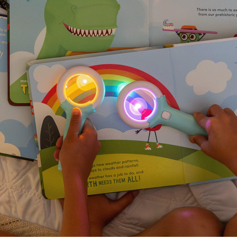children using magic magnifier to reveal glowing colors on a page