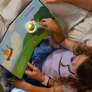 children using the magic magnifier to reveal glowing elements on a page