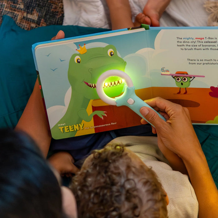 group reading while a dinosaur page lights up under the magnifier