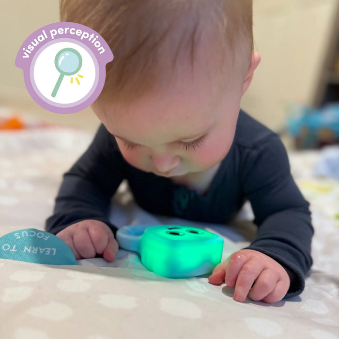 baby during tummy time watching glowing blair rattle