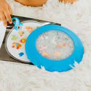 peekaboo sensory bag clipped to a book with child searching for figurines
