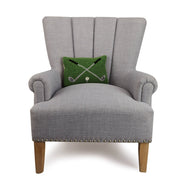 Gray armchair with a green cushion featuring a pattern on a white background