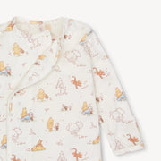 Baby onesie with Winnie the Pooh pattern on a white background