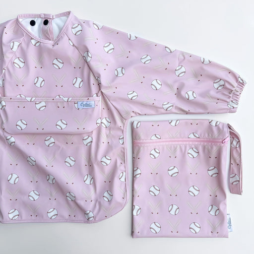 Pink baby bib and pouch with baseball pattern on a white background