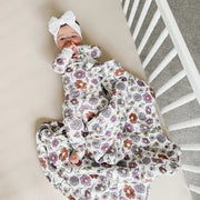 baby lying in crib wearing gunamuna bouquet sleep bag tog 2.5