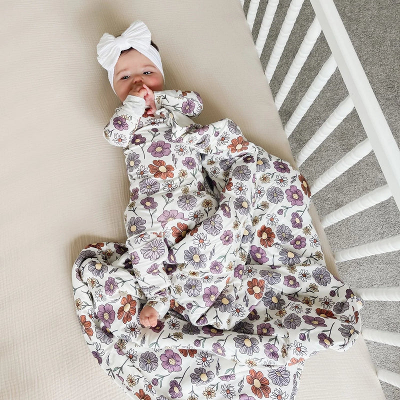 baby lying in crib wearing gunamuna bouquet sleep bag tog 2.5