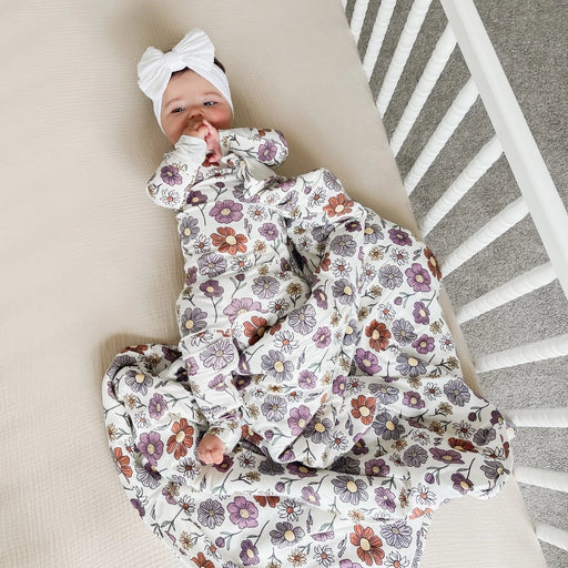 baby lying in crib wearing gunamuna bouquet sleep bag tog 2.5