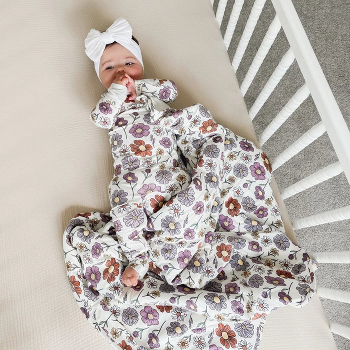 baby lying in crib wearing gunamuna bouquet sleep bag tog 2.5