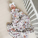 baby lying in crib wearing gunamuna bouquet sleep bag tog 2.5