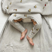 closeup of baby legs out through bottom zipper opening of gunamuna pooh sleep bag