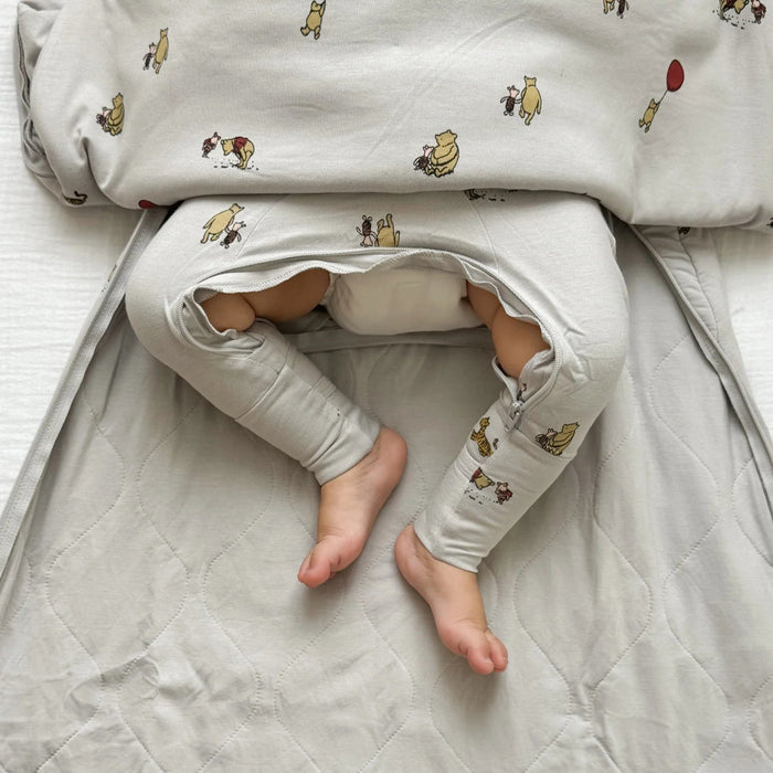 closeup of baby legs out through bottom zipper opening of gunamuna pooh sleep bag