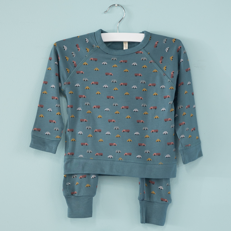 Children's blue sweatsuit with car pattern on a light blue background