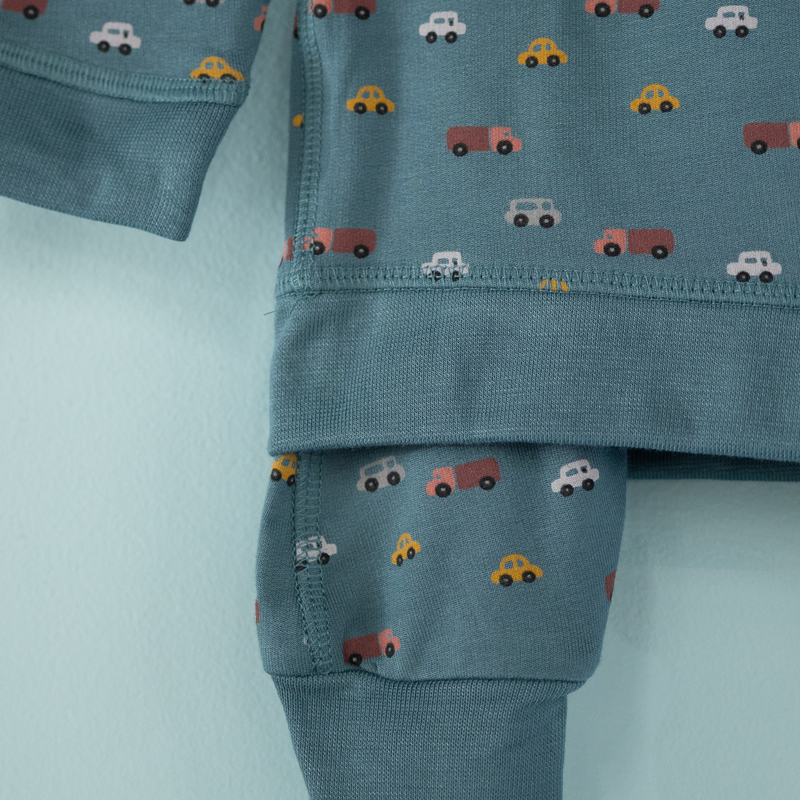Children's outfit with car pattern on a light blue background