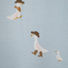 Pattern of ducks wearing hats and boots on a light blue background