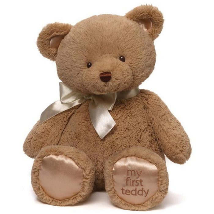 GUND Baby My First Teddy in tan with satin bow and “my first teddy” paw pads on white background