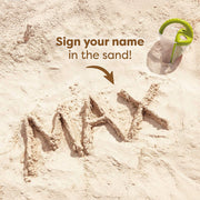 Name 'MAX' written in sand with a sand writing tool on a sandy background