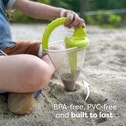 Child playing with a green sand toy in a sandbox, with text indicating BPA-free and PVC-free materials.