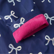 Close-up of adjustable cuff showing pink lining and bow print