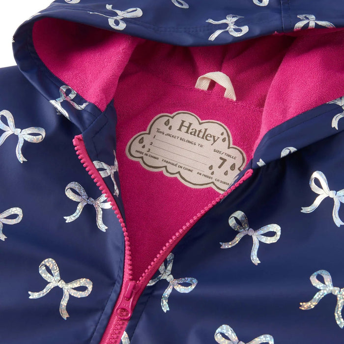 Close-up of pink fleece-lined hood and zipper on foil bows rain jacket