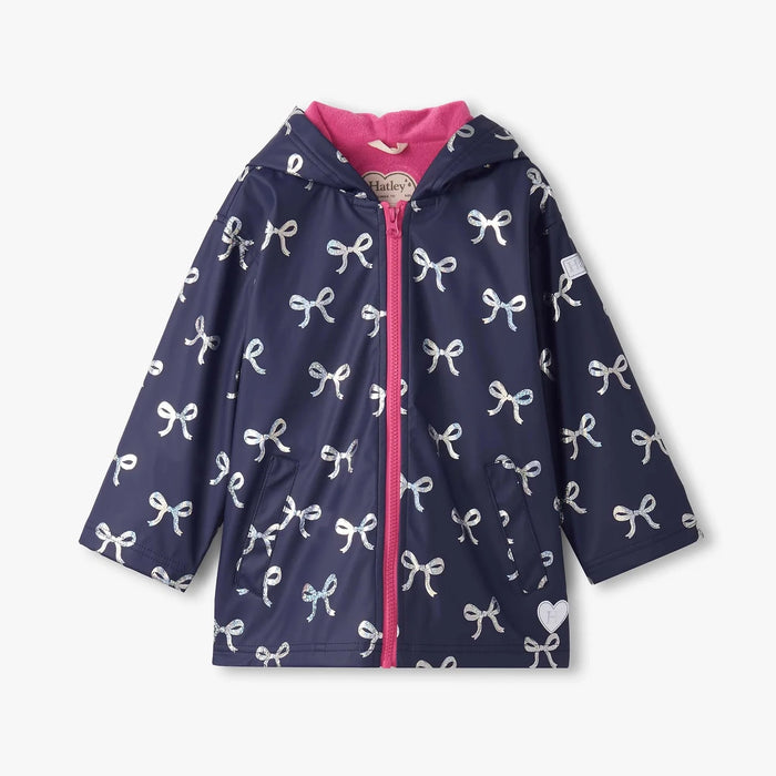 Navy girls rain jacket with white foil bow print and pink lining, hooded front view