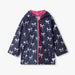 Navy girls rain jacket with white foil bow print and pink lining, hooded front view