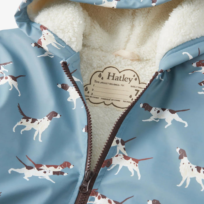 Close-up of cream sherpa lining and zipper on dog print rain jacket