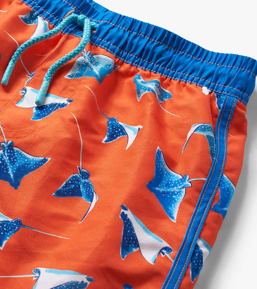 Orange swim shorts with blue stingray pattern on a white background