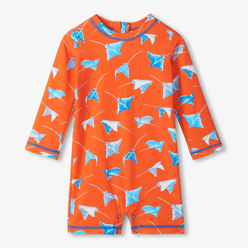 Orange children's swimsuit with blue stingray pattern on a white background