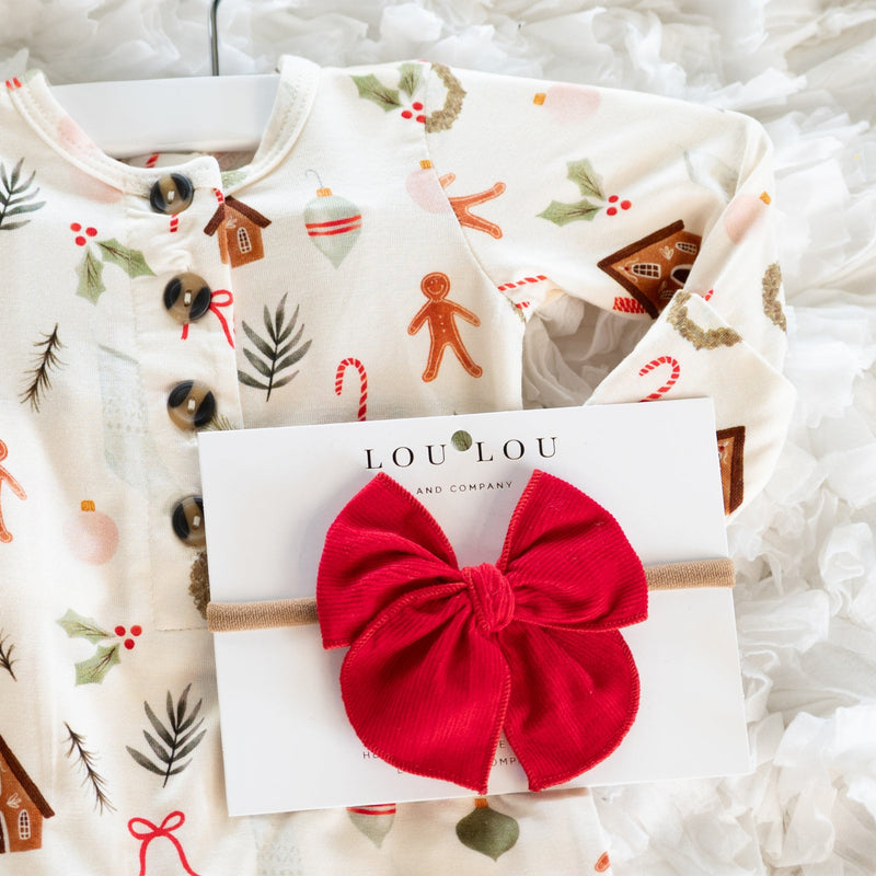 Children's Christmas-themed shirt with a red corduroy bow and LouLou brand card on a white textured background