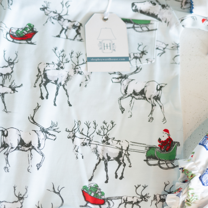 baby pajamas with reindeer and sleigh pattern on a white background