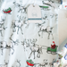 baby pajamas with reindeer and sleigh pattern on a white background