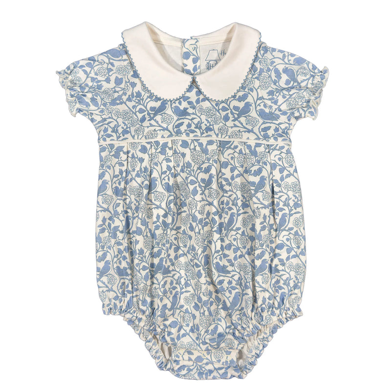 Baby romper with blue floral pattern and white collar on a white background