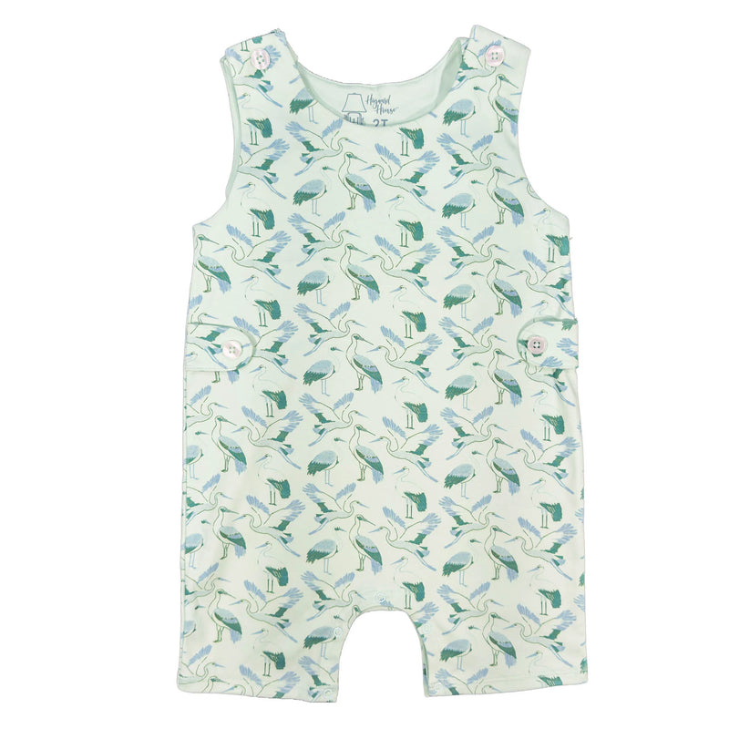 Children's sleeveless romper with stork pattern on a light green background