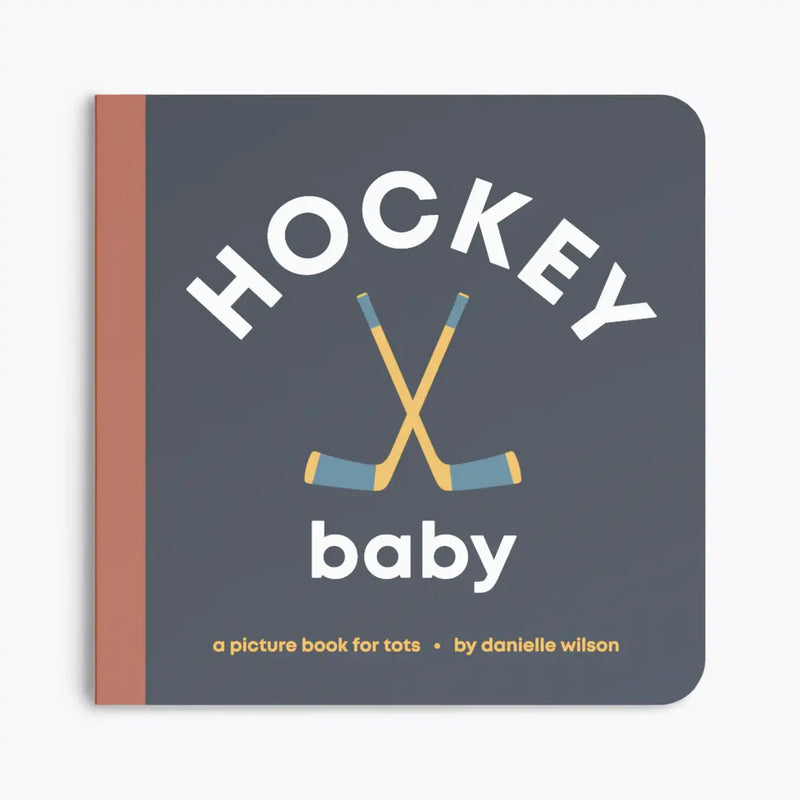 Book titled 'Hockey Baby' with hockey sticks on a gray background