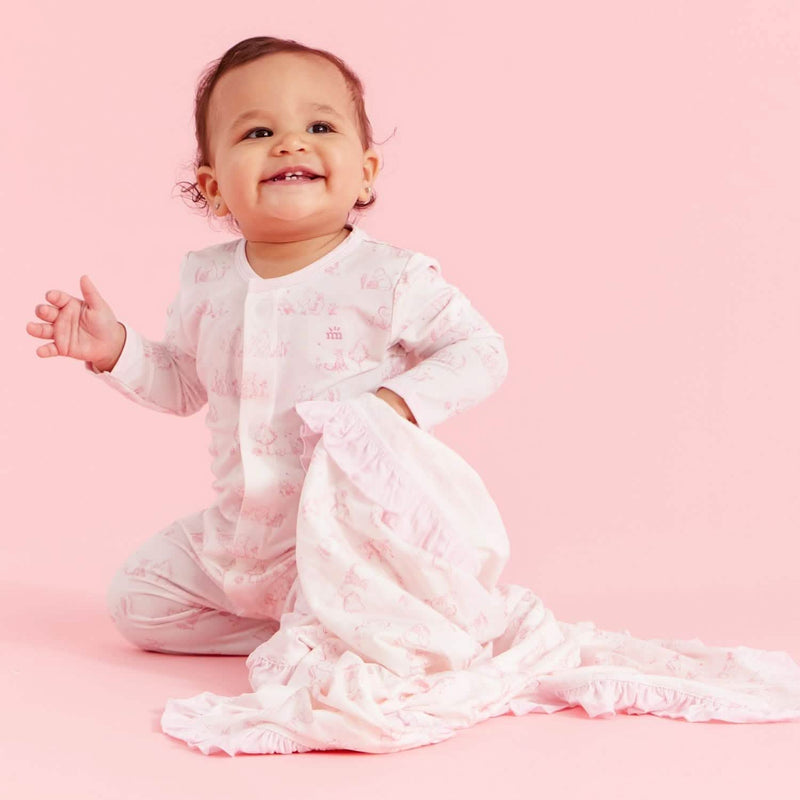 Baby wearing Sweeter Than Hunny magnetic ruffle footie on pink background