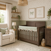 Nursery room with wooden crib, beige armchair, and decorative elements.