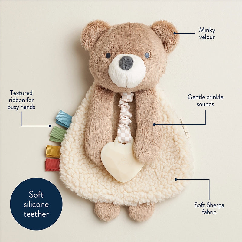 Itzy Ritzy Theo the Bear lovey features: minky velour, gentle crinkle sounds, soft Sherpa fabric, textured ribbons and a soft silicone teether