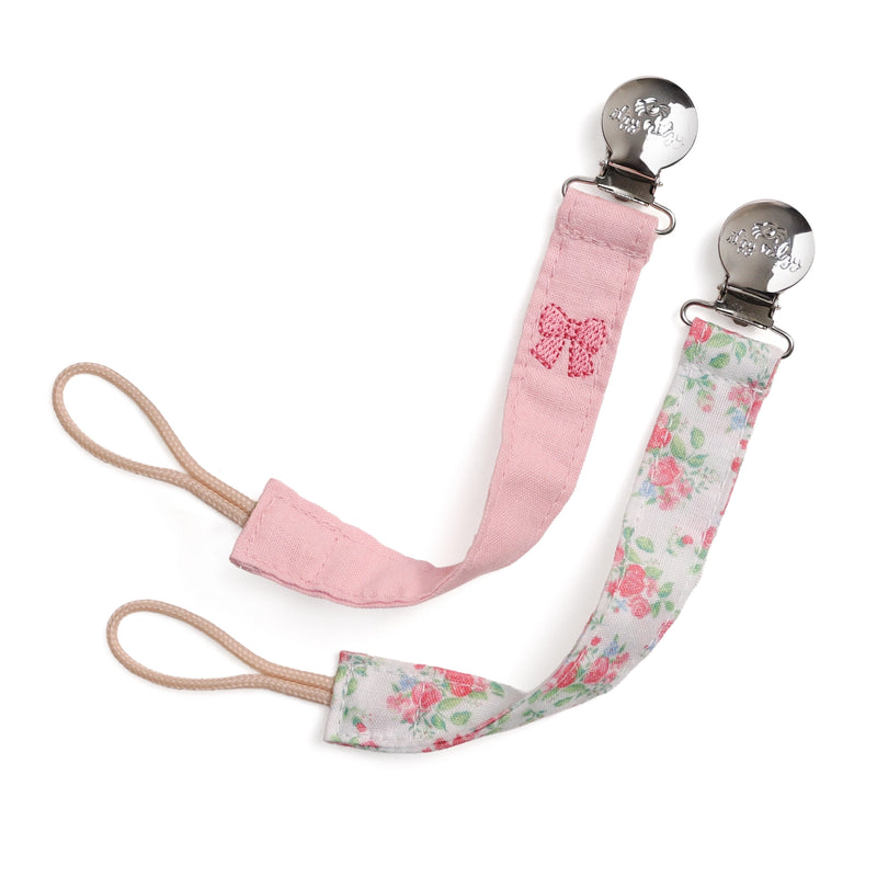 Pink and floral pacifier clip on a white background