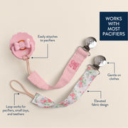 Pink pacifier clip with floral design on a beige background, featuring text describing its features.