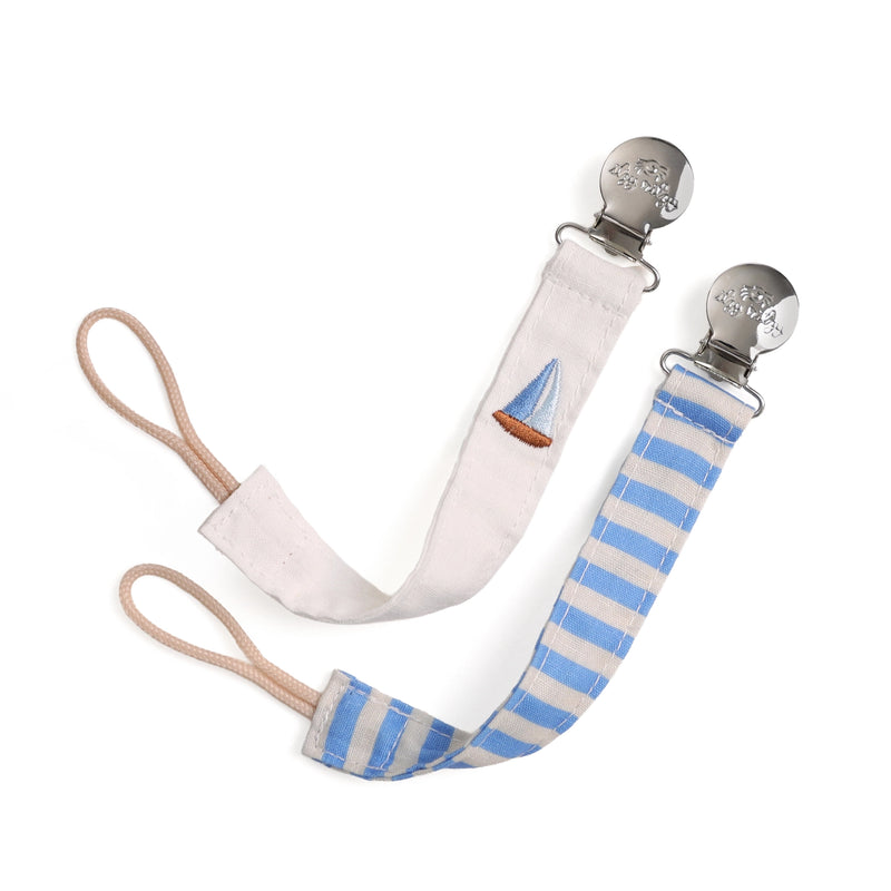 Pacifier clip with blue and white striped strap and sailboat design on a white background