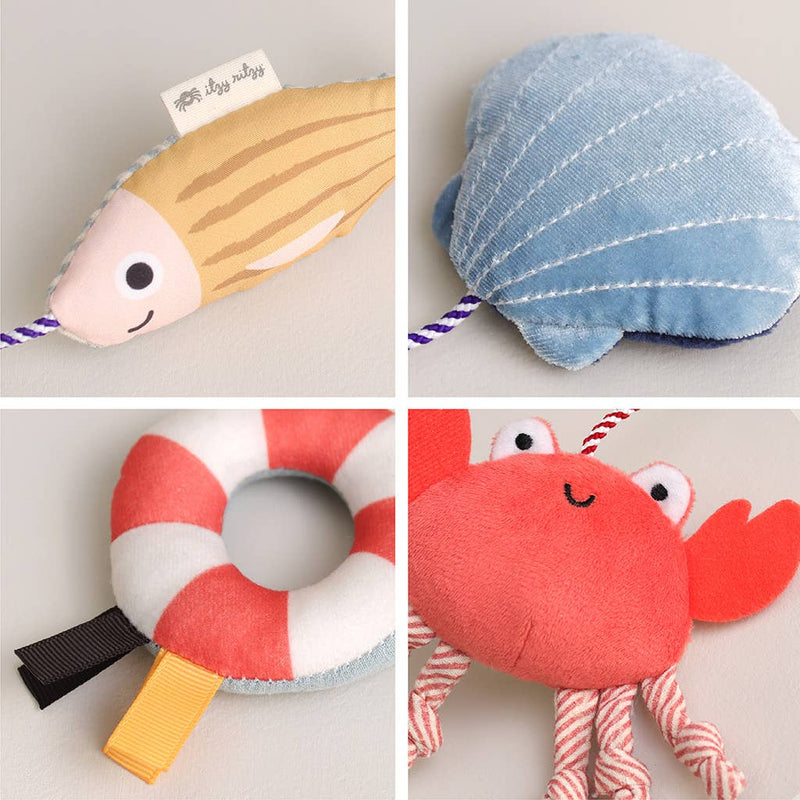 Four plush toys shaped like a fish, shell, life buoy, and crab on a light gray background.