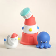Stack of colorful stacking toys with a duck and octopus on a beige background