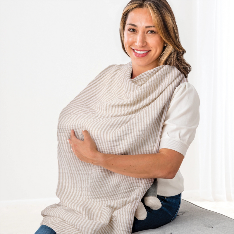 Woman using a baby wrap carrier on a white background