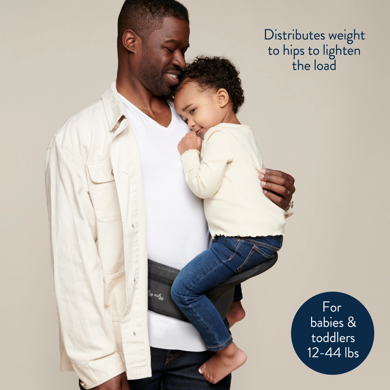 Man holding a child on a baby carrier with text about weight distribution and age range.