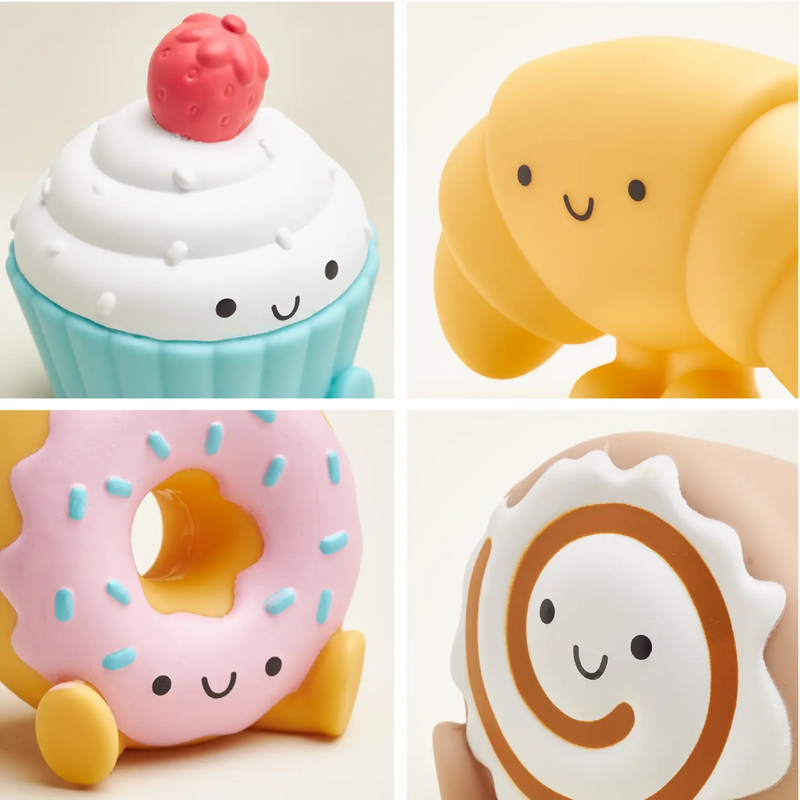 Close-up of soft squeezy bakery-themed play pieces including donut and dessert characters