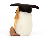 Side/back view of the graduation egg plush showing the cap and soft cream body