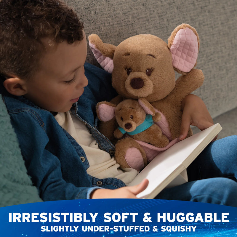 Child reading with Kanga and Roo plush cuddled on a chair