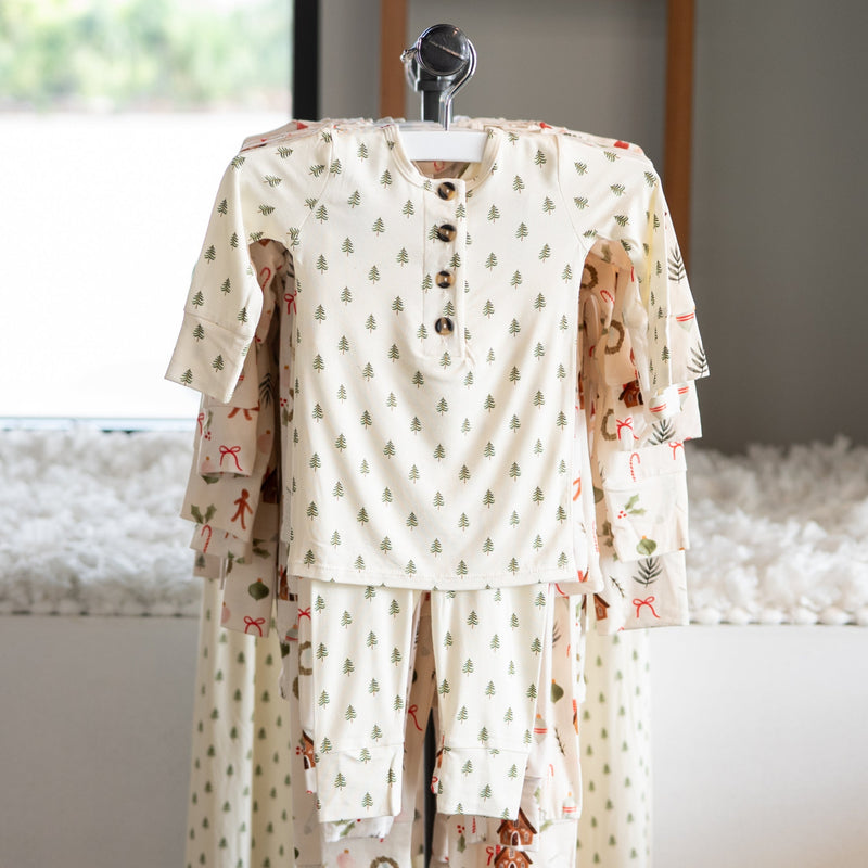 Christmas tree patterned pajama set on a mannequin against a neutral background