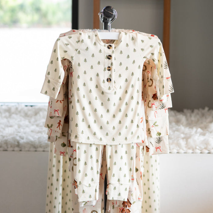 Christmas tree patterned pajama set on a mannequin against a neutral background