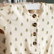 Baby onesie with tree pattern on a hanger 